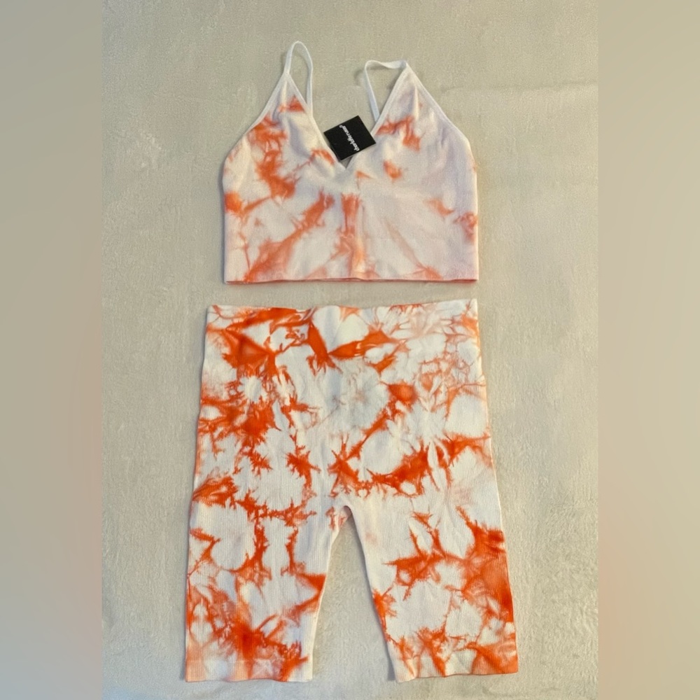 NWT. Charlotte Russe 2-piece biker shorts with matching bralette. Size L.